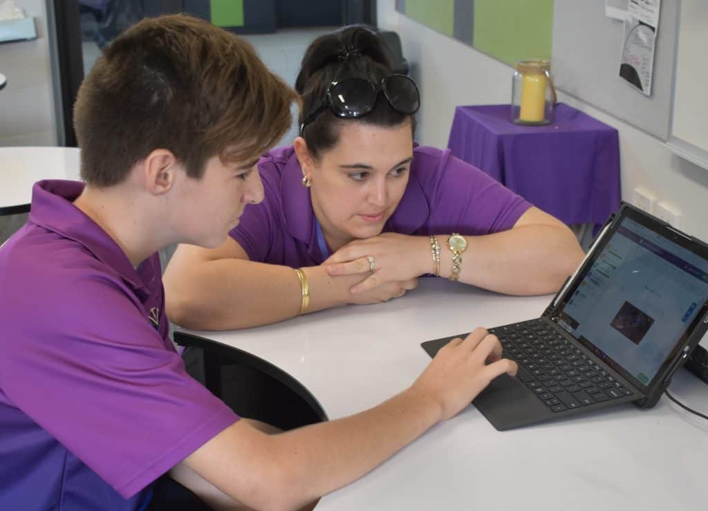 Student and teach at outstanding school in Cairns work together on laptop