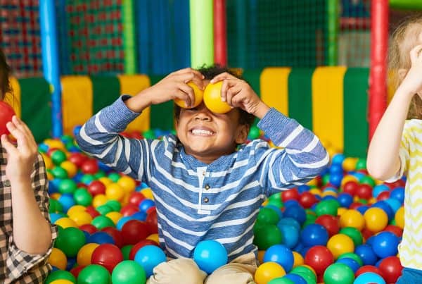 children play indoor with balls on a rainy day