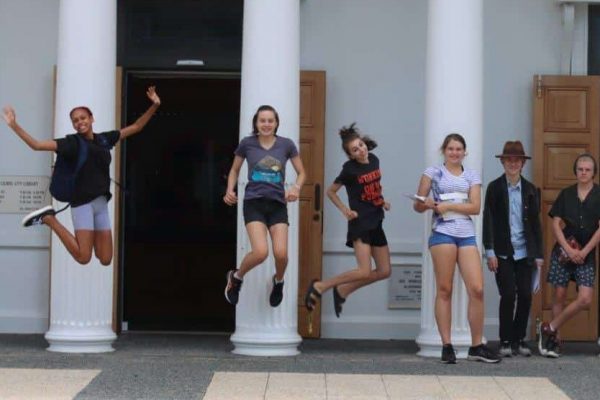 kids jumping for joy on trip at school