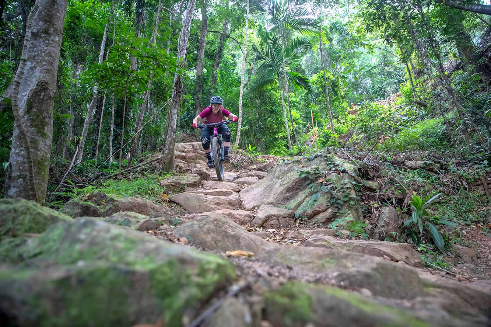 PakMag Cairns - Boy riding through the rainforest